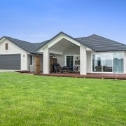 Twin peaks  distinctive roof forms are all cottage, elevation, estate, facade, farmhouse, grass, home, house, land lot, landscape, lawn, property, real estate, residential area, roof, siding, sky, villa, yard, green, teal