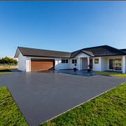 Low -set and sprawling, this Feilding home won architecture, elevation, estate, facade, home, house, land lot, landscape, property, real estate, residential area, sky, villa, teal