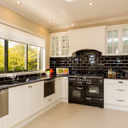 This kitchen exudes old-fashioned charm, from the freestanding cabinetry, countertop, cuisine classique, interior design, kitchen, property, real estate, room, white