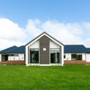 This multi-award winning home stands proud on the barn, cottage, elevation, estate, facade, farmhouse, grass, home, house, land lot, landscape, property, real estate, residential area, roof, rural area, siding, sky, white, green