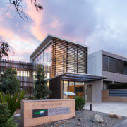 The retiring generation  baby boomers  are architecture, building, condominium, corporate headquarters, elevation, facade, home, house, property, real estate, residential area, teal