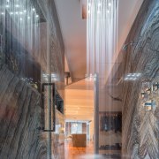 Granite lines this apartment shower enclosure, while the apartment, architecture, ceiling, daylighting, glass, home, house, interior design, lobby, gray