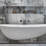 Supported by a ledge and pedestal, this tub bathtub, floor, plumbing fixture, tap, tile, gray