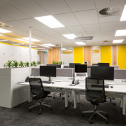 The locker surrounds and wall accents are yellow ceiling, conference hall, desk, furniture, interior design, office, product design, white, gray, black