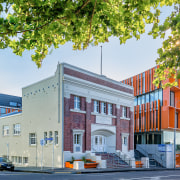 The Orange is a mixed-use Auckland development combining apartment, architecture, building, city, commercial building, elevation, facade, home, house, metropolitan area, mixed use, neighbourhood, real estate, residential area, white