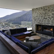 This outdoor room in a hillside house by architecture, fireplace, hearth, home, house, interior design, living room, penthouse apartment, property, real estate, gray