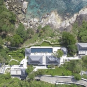 A steep drive leads down to this coastal aerial photography, bird's eye view, estate, geological phenomenon, hill station, home, house, mountain village, property, real estate, suburb, tree, village, green