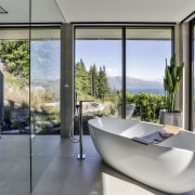 This sculptural tub sits in its own glass architecture, house, interior design, real estate, window, gray