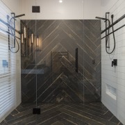 Contributing to this master suites dramatic black and bathroom, floor, flooring, glass, interior design, plumbing fixture, room, shower, tile, wall, gray, black