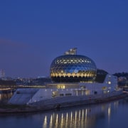 The glass-clad Auditorium is the crowning glory on architecture, building, city, dawn, daytime, dusk, evening, horizon, landmark, night, reflection, river, sky, structure, tourist attraction, water, water resources, waterway, blue