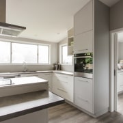 This large scullery in a kitchen by Callidus cabinetry, countertop, cuisine classique, interior design, kitchen, real estate, gray