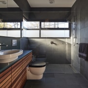 Slate tile flooring and matching wall tiles combine architecture, bathroom, room, black