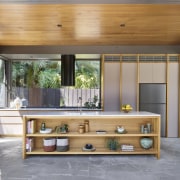 Kitchen with window splashback, wood accented cabinetry and 