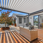 A pergola forms the central spine, casting shifting 