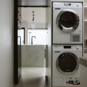 The original laundry was converted into a scullery/laundry. clothes dryer, home appliance, laundry, laundry room, major appliance, room, washing machine, gray