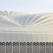 The stadium’s roof design is an abstraction of architecture, line, textile, white