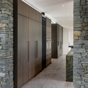 Wall of closed wood-veneer cabinets behind the kitchen 