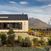 Front approach with generous drive and low-up-keep plantings. 