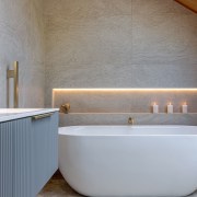 The freestanding tub takes up less space while 