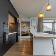 Expansive kitchen with contemporary island pendants. 
