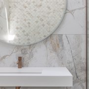 The large round vanity wall mirror adds to 