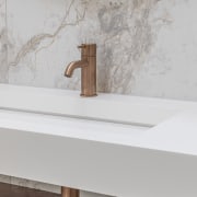 Bronze tapware and fittings reinforce the overall warmth 