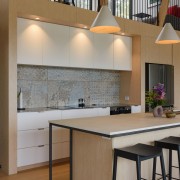 Kitchen, breakfast seating and mezzanine floor above. 