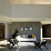 Upstairs is accessed via an open tread stairway architecture, building, ceiling, coffee table, design, floor, flooring, furniture, home, house, interior design, living room, lobby, property, real estate, room, table, tile, wall, gray