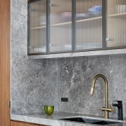 The reeded glass overhead cupboard doors, framed in 