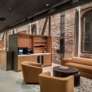 Furniture and cabinetry tones with teh red brickwork. 