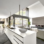 The home's centrally located crisp white kitchen overlooks 