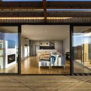 Spatially, the living wing aligns with the north, door, house, interior design, real estate, window, brown