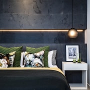 Concealed lighting sets off the stone bedhead wall 