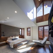The master bedroom occupies a dynamic volume, while 