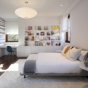 This child's bedroom includes built-in display shelving and 