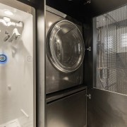 The laundry cabinet accommodates a washing machine and 