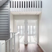 The home's timber weatherboard lined walls connect back 