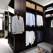 A walk-in wardrobe space with a place for 