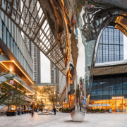 The frontage is marked by a sculptural stainless 