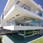 Reflection pools beside this contemporary beachfront house reflect apartment, architecture, building, commercial building, condominium, corporate headquarters, facade, house, mixed use, property, real estate, residential area, villa, gray