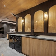 The laundry is screened off from the banquette 