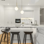 The kitchen design accentuates the villa's existing tall 