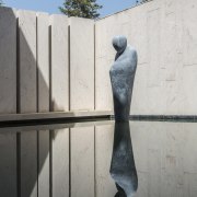 A monk levitating over water? Just one more architecture, art, monument, sculpture, statue, wall, gray, white