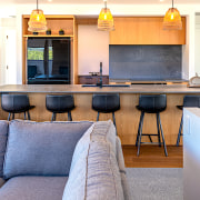 Feature lighting sets off this simple yet dramatic architecture, building, cabinetry, floor, flooring, furniture, home, house, interior design, kitchen, living room, loft, property, real estate, room, suite, table, yellow, white