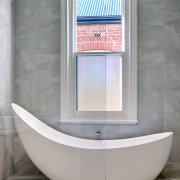 The tub makes a strong end-of-room statement in architecture, bathroom, bathtub, door, floor, flooring, interior design, plumbing fixture, property, room, tile, wall, window, gray