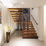 The open timber stairs at front entry. - 