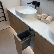 A dedicated waste bucket is integrated into the 