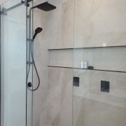 Black fittings set off the shower enclosure. 