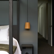 Resort-style poster bed and hallway access. 