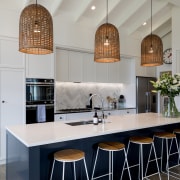 Three birdcage-like pendants are centred over the new 